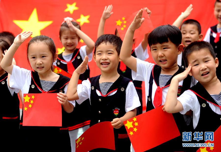  9月28日，安徽淮南市直機(jī)關(guān)幼兒園的小朋友在國旗前唱《國歌》，慶祝祖國65周歲生日。