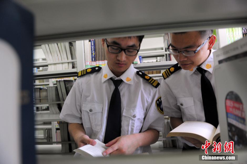 5月8日，武漢輕工大學(xué)圖書館保安吳濤與江力在圖書館交流學(xué)習(xí)。