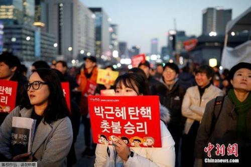 資料圖：當(dāng)?shù)貢r間3月10日上午，韓國憲法法院就總統(tǒng)彈劾案審判，樸槿惠被立即免去總統(tǒng)職務(wù)。當(dāng)晚，韓國民眾走上首爾街頭舉行燭光集會。