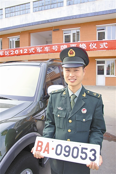 駐京某部長途汽車隊中士王志濤領(lǐng)到新式軍車號牌。